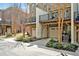 Townhome exterior with garage access and balcony, surrounded by mature trees at 138 Tressel Way, Durham, NC 27707