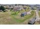Aerial view of the backyard featuring a detached two-car garage, green space, and mature trees at 1408 Harvey Johnson Rd, Raleigh, NC 27603