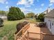 Backyard deck with an outdoor dining area and view of the lush lawn at 1408 Harvey Johnson Rd, Raleigh, NC 27603