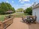 Back deck with a dining table and chairs overlooking the yard at 1408 Harvey Johnson Rd, Raleigh, NC 27603