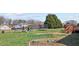 Large backyard featuring a playset, trampoline, and green grass at 1408 Harvey Johnson Rd, Raleigh, NC 27603