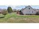 Backyard features a trampoline, wooden deck, and lush green grass; home has gray vinyl siding at 1408 Harvey Johnson Rd, Raleigh, NC 27603