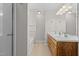 Bathroom featuring double sinks, wood cabinets, and shower/tub combo at 1408 Harvey Johnson Rd, Raleigh, NC 27603