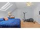 Comfortable bedroom with a skylight, ceiling fan, and workout equipment at 1408 Harvey Johnson Rd, Raleigh, NC 27603