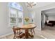 Bright breakfast nook features a wood table, seating, and a large arched window for pleasant natural light at 1408 Harvey Johnson Rd, Raleigh, NC 27603
