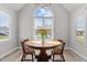 Bright breakfast nook features a wood table, seating, and a large arched window for pleasant natural light at 1408 Harvey Johnson Rd, Raleigh, NC 27603
