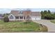 Attractive exterior of the house featuring a manicured lawn and an attached garage at 1408 Harvey Johnson Rd, Raleigh, NC 27603