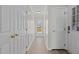 Hallway boasts bright white walls, wood-look flooring and access to the backyard at 1408 Harvey Johnson Rd, Raleigh, NC 27603