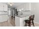 Open kitchen boasts granite counters, stainless appliances, bar seating, and white cabinetry at 1408 Harvey Johnson Rd, Raleigh, NC 27603