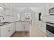 Open kitchen boasts granite counters, stainless appliances, bar seating, and white cabinetry at 1408 Harvey Johnson Rd, Raleigh, NC 27603
