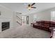 Bright living room features a fireplace and a ceiling fan, with view to dining area at 1408 Harvey Johnson Rd, Raleigh, NC 27603