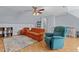 Spacious living room showcasing comfortable seating, wood-look floors, and a ceiling fan at 1408 Harvey Johnson Rd, Raleigh, NC 27603