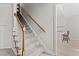 Carpeted stairs with wooden handrail lead to the upper level, open to the kitchen at 1408 Harvey Johnson Rd, Raleigh, NC 27603