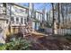 Charming townhome backyard with a spacious deck and stairs leading to the lush surroundings at 1515 Edgeside Ct, Raleigh, NC 27609