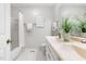 Clean bathroom with a double vanity, bathtub with shower, and white hexagon tile flooring at 1515 Edgeside Ct, Raleigh, NC 27609