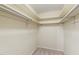 Spacious walk-in closet with ample shelving and carpeted floor at 1515 Edgeside Ct, Raleigh, NC 27609