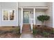Front porch with decorative door, brick steps and landscaped bushes at 1515 Edgeside Ct, Raleigh, NC 27609
