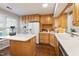 Bright kitchen features wooden cabinets, white countertops, an island, and modern appliances at 1515 Edgeside Ct, Raleigh, NC 27609