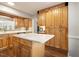 Spacious kitchen with wooden cabinets, white island cooktop, and ample storage at 1515 Edgeside Ct, Raleigh, NC 27609
