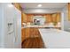 Well-lit kitchen showcases wood cabinetry, white countertops, and modern appliances at 1515 Edgeside Ct, Raleigh, NC 27609