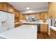 Charming kitchen with wood cabinets, white countertop island, and modern appliances at 1515 Edgeside Ct, Raleigh, NC 27609
