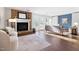 Open living room featuring hardwood floors, a stone fireplace and a modern sofa at 1515 Edgeside Ct, Raleigh, NC 27609