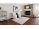 Bright living room with cozy fireplace, white chairs and neutral rug at 1515 Edgeside Ct, Raleigh, NC 27609