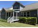 Scenic backyard with a screened-in porch and well-maintained lawn, perfect for relaxation and entertaining at 1564 Highpoint St, Wake Forest, NC 27587