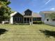 Expansive backyard showcasing lush green lawn, complemented by a screened porch, perfect for outdoor enjoyment at 1564 Highpoint St, Wake Forest, NC 27587