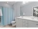 Bright bathroom featuring shower/tub combo, neutral blue paint, and vanity at 1564 Highpoint St, Wake Forest, NC 27587