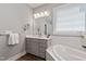 Bright bathroom featuring vanity, soaking tub, and neutral gray walls at 1564 Highpoint St, Wake Forest, NC 27587