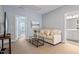Neutral bedroom featuring soft sofa, painting, and bright light at 1564 Highpoint St, Wake Forest, NC 27587
