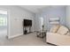 Neutral bedroom featuring soft sofa, painting, and bright light at 1564 Highpoint St, Wake Forest, NC 27587