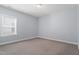 Empty bedroom featuring neutral carpet and bright window at 1564 Highpoint St, Wake Forest, NC 27587