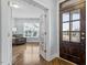 Bright foyer with hardwood floors, a stylish front door, and a glimpse into the living area at 1564 Highpoint St, Wake Forest, NC 27587