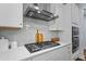 New kitchen features stainless steel appliances, a tile backsplash, and white marble countertops at 1564 Highpoint St, Wake Forest, NC 27587