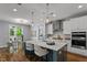 Modern kitchen with stainless steel appliances, large island, and adjacent dining area at 1564 Highpoint St, Wake Forest, NC 27587