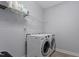 Well-equipped laundry room with modern washer and dryer, complemented by storage shelves for added convenience at 1564 Highpoint St, Wake Forest, NC 27587