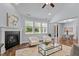 Bright living room with fireplace, windows, and adjacent dining area at 1564 Highpoint St, Wake Forest, NC 27587