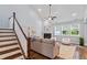 Living room with fireplace, staircase, and large windows at 1564 Highpoint St, Wake Forest, NC 27587