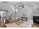 Open living room with soaring ceilings, fireplace, and access to the staircase at 1564 Highpoint St, Wake Forest, NC 27587