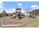 Community playground with slide, climbing structure, and wood chip ground covering for Gathering fun at 1564 Highpoint St, Wake Forest, NC 27587