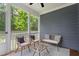 Cozy screened porch featuring wicker furniture and a view of the lush backyard at 1564 Highpoint St, Wake Forest, NC 27587