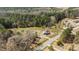 Aerial view of country property featuring lush trees and a home near a two-lane road at 1855 W West River Rd, Franklinton, NC 27525