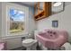 Retro bathroom featuring pink fixtures, wood cabinet, and natural light at 1855 W West River Rd, Franklinton, NC 27525