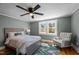 The Primary bedroom features natural light, hardwood floors, and a comfortable accent chair, creating a relaxing sanctuary at 1855 W West River Rd, Franklinton, NC 27525