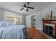 Bedroom featuring a decorative fireplace, hardwood floors, and neutral paint at 1855 W West River Rd, Franklinton, NC 27525