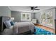 The bedroom boasts natural light, French doors to a deck, and an accent chair, creating a tranquil retreat at 1855 W West River Rd, Franklinton, NC 27525