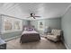 The room is bathed in natural light, featuring a cozy accent chair and plush carpeting for ultimate comfort at 1855 W West River Rd, Franklinton, NC 27525