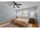 Bedroom with hardwood floors, neutral paint, ceiling fan, and warm bedding at 1855 W West River Rd, Franklinton, NC 27525